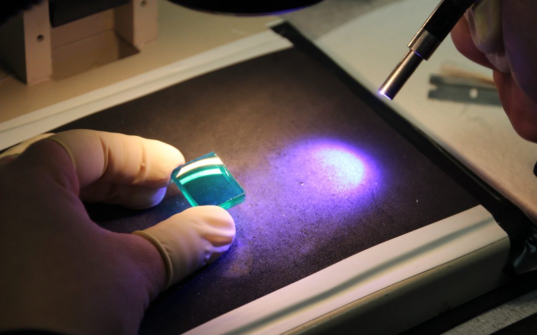 Image of a scientist working in an optics metrology lab for an article describing what optics metrology is.