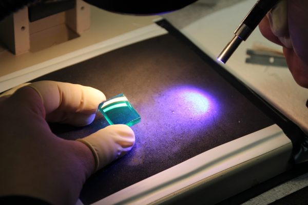 Image of a scientist working in an optics metrology lab for an article describing what optics metrology is.